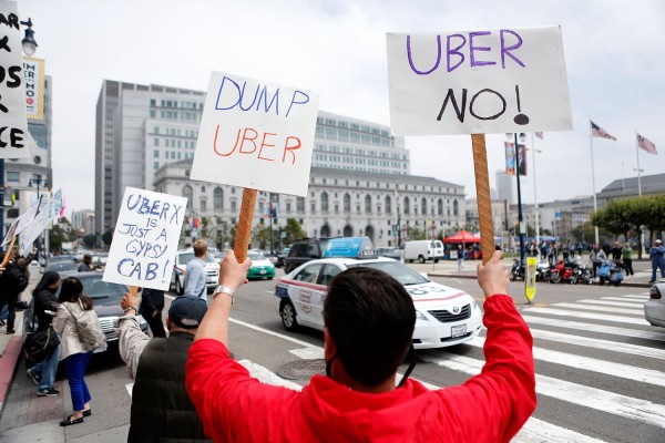 San Francisco taxi drivers show their opposition to Uber which taxi drivers say is operating illegally in San Francisco